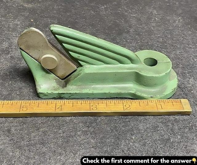 A close-up of a vintage leather strap cutter, showing its compact, functional design used for cutting uniform leather strips